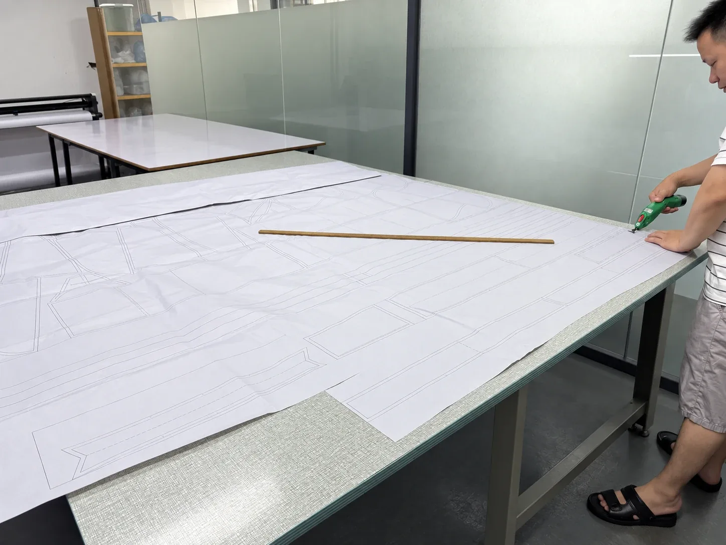 Pattern pieces laid out on the development table before cutting at the Humen factory