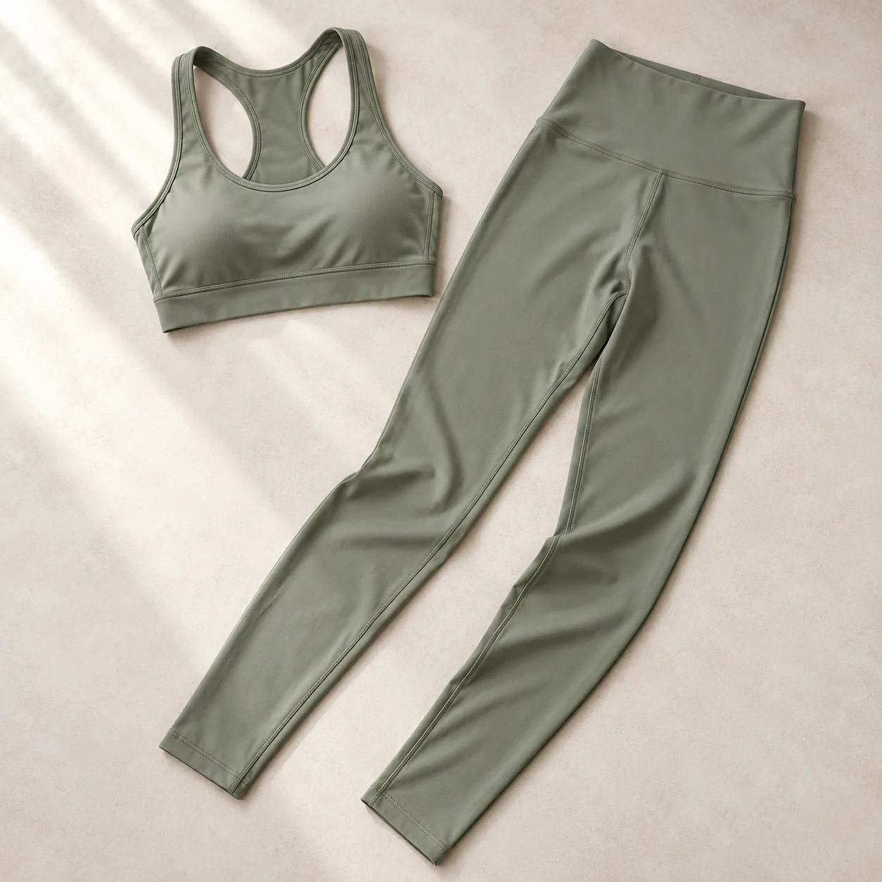 AI design concept of a sage yoga bra and leggings laid flat to show their silhouettes