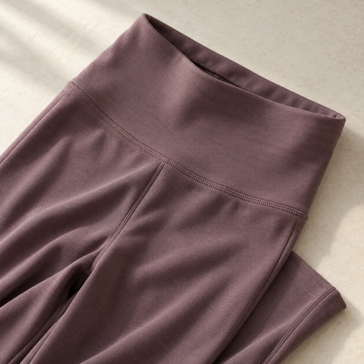 AI design concept of a plum yoga-legging waistband and fabric surface